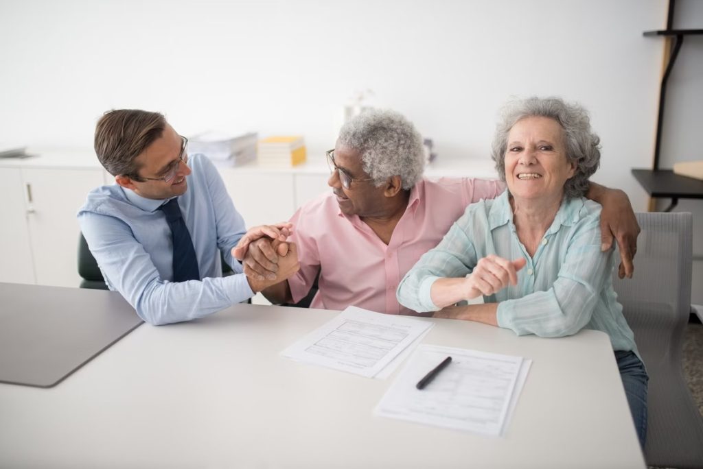 A friendly Courtesy Cash agent reviewing loan options with a smiling local couple