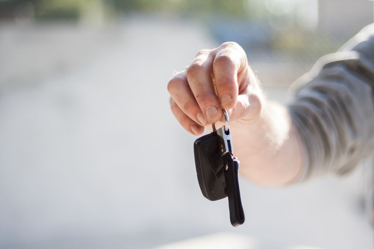 Close-up of car keys being handed across a desk after a title loan agreement at Courtesy Cash